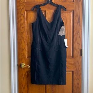 Fitted black dress with white stitch accent